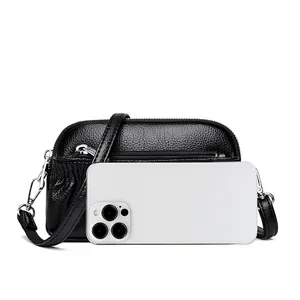 Genuine leather crossbody shell bag with pebble grain texture and triple zippers