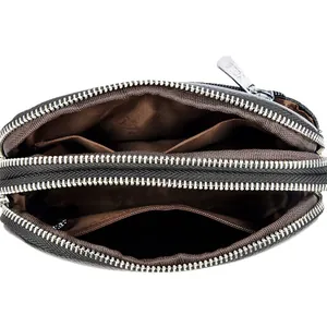 Black pebbled leather crossbody bag with three zipper compartments and card slots