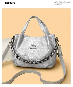 Close-up of silver snakeskin leather texture with kangaroo logo and chain detail