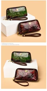 Detail of vintage embossed leather clutches with peony patterns in green and brown