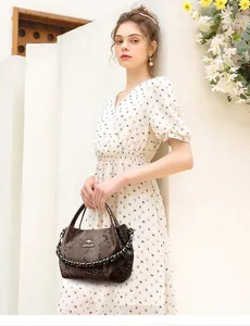 Detailed view of coffee snakeskin texture handbag with gold chain and kangaroo logo