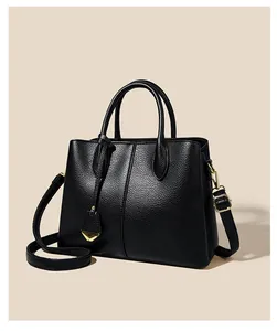 Detailed close-up of premium black lychee pattern leather texture and golden metal hardware