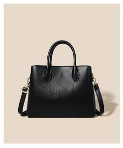 Detailed macro view showing the premium black lychee grain leather texture of this handbag