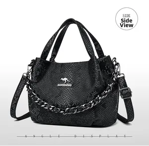 Detail of black snake pattern handbag with silver chain and metal kangaroo logo