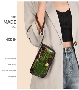 Detailed relief of peony flowers on vintage green leather clutch with gold hardware