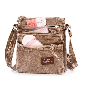 Vintage brown washed denim crossbody bag with triple zipper layers and ample storage space