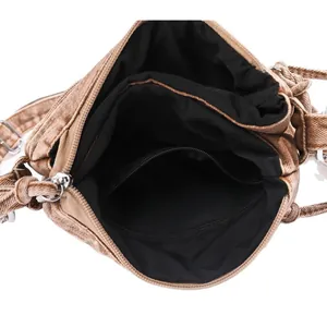 Brown distressed denim bucket bag featuring multi-compartment interior with silver zipper