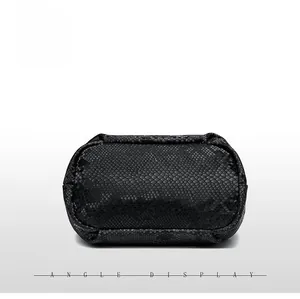 Macro bottom view of black snakeskin pattern leather handbag with precise stitching