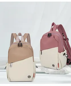 Detail of color-block casual backpacks with drawstring side pockets and metal logo