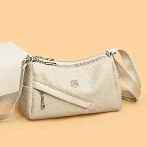 Chic cream woven leather crossbody bag with kangaroo logo and wide fabric strap