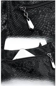 Macro detail of black snakeskin texture handbag with silver zipper pocket and metal slider
