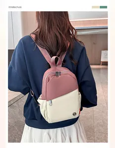 Close-up of a two-tone pink and beige mini backpack showing durable nylon texture and straps