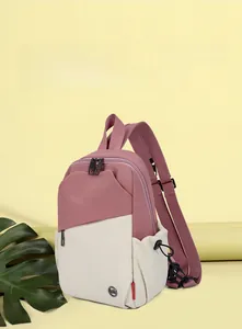 Detail view of pink and beige contrast color backpack with zipper and side pocket