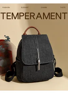 Detail of denim backpack with silver metal fringe tassels and brown leather handle