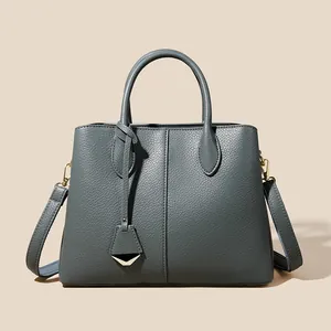 Blue-grey lychee pattern leather tote bag with dual handles and detachable shoulder strap
