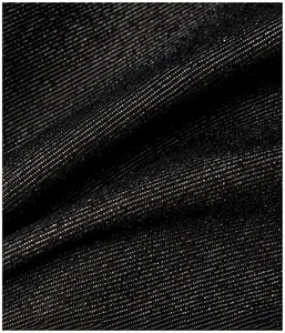 Close-up of durable black washed denim fabric with dense twill weave and texture