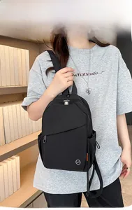 Close-up of black nylon multi-zipper backpack with LST logo in a library setting
