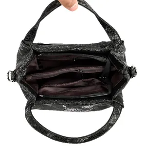 Snake embossed leather handbag featuring double zipper compartments and metal hardware