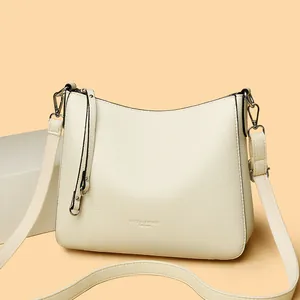 Chic off-white litchi grain leather bucket bag with wide strap and silver hardware
