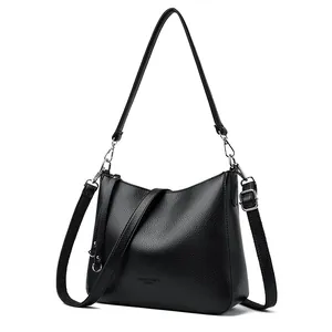 Creative black pebble leather bucket bag with dual straps and silver hardware detail