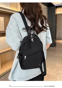 Detail view of water-resistant black nylon backpack with multi-zipper layers and LST logo