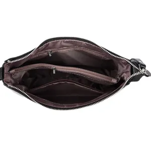 Interior of black leather bucket bag showing organized compartments and brown satin lining