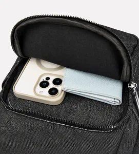 Interior view of denim backpack showing capacity for a smartphone and a leather wallet