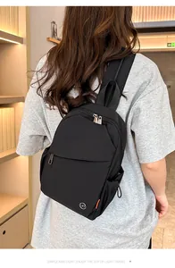 Detail of waterproof black nylon backpack with drawstrings and metal LST logo
