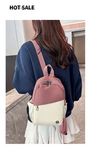 Rear view of model wearing pink and beige two-tone lightweight nylon mini backpack