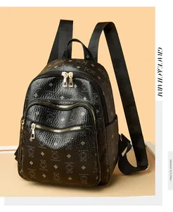 Close-up of black PU leather backpack featuring teddy bear print and gold zippers