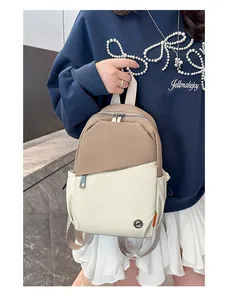 Detail of khaki and beige contrast mini backpack featuring waterproof nylon and zip pockets