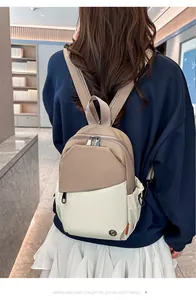 Detail of khaki and beige contrast mini backpack with metal logo and zipper pocket