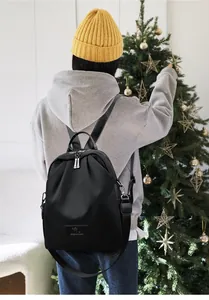Détail du sac à dos en nylon imperméable avec logo kangourou en cuir et zips métalliques