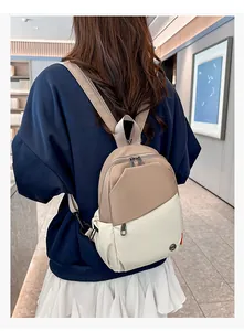 Detail showing contrast color mini backpack worn by model to highlight size and fit