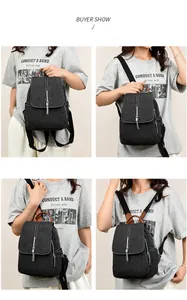 Close-up of washed denim backpack featuring chain tassel detail and leather trim accents