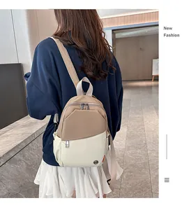 Detailed back view of khaki and cream contrast backpack with adjustable straps on a model