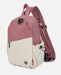 Detailed 45-degree side view of pink and beige nylon crossbody bag with metal zippers