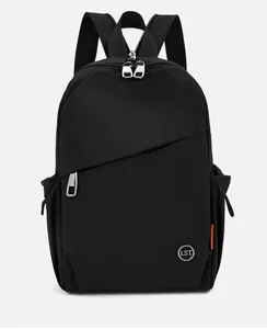 Macro detail of black nylon backpack featuring side pockets and a sleek metal logo plaque