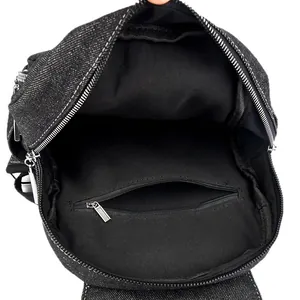 Spacious main compartment of washed denim backpack with metal zipper inner pocket