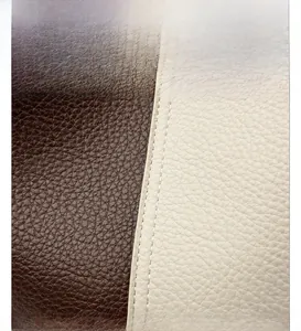 Close-up of pebble grain leather texture with white stitching in brown and cream