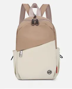 Detail of multi-functional contrast color backpack featuring metal logo and zipper pocket