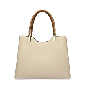 Minimalist beige leather tote bag with brown handles and gold hardware for women