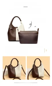 Close-up of contrast-color leather tote set with teddy bear charm and inner pouch