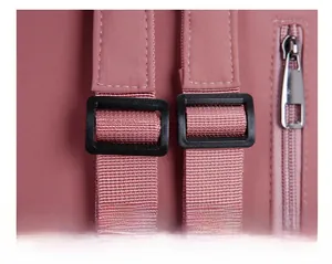 Detail view of adjustable plastic shoulder strap buckle and zipper on pink nylon backpack