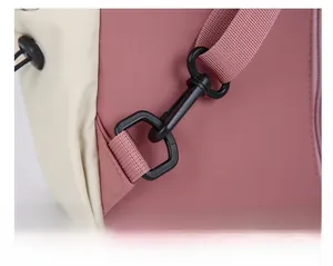 Detail of the high-strength plastic swivel hook and durable nylon webbing on the pink backpack
