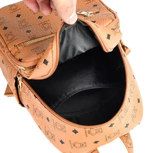 Brown printed backpack with bear patterns and open main compartment showing inner pocket