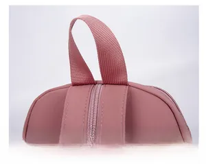 Detail shot of the pink backpack showing the durable woven handle and matching zipper closure