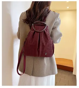 Detailaufnahme der burgunderroten Bucket-Bag mit Leopardenmuster und Metallgriff
