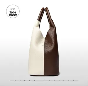 Side view showing bicolor cream and brown leather texture on stylish bucket bag