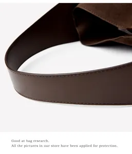 Macro detail of dark coffee suede bucket bag with premium leather stitching and crafts